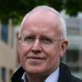 A photo of an individual called Peter Rickaby who is wearing a black coat, glasses and is looking at the camera.